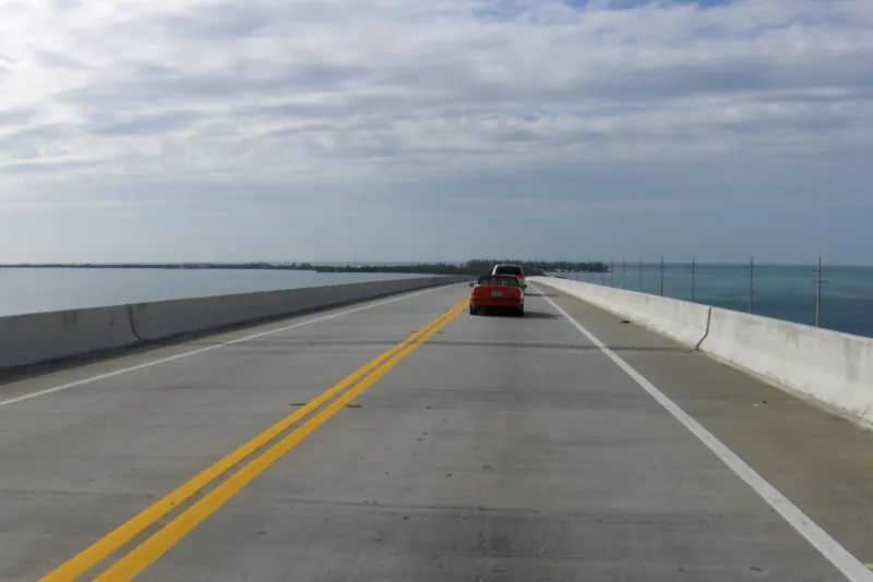 Overseas Highway bridge crossing open water between Key Largo and Key West, Florida, seen from a car