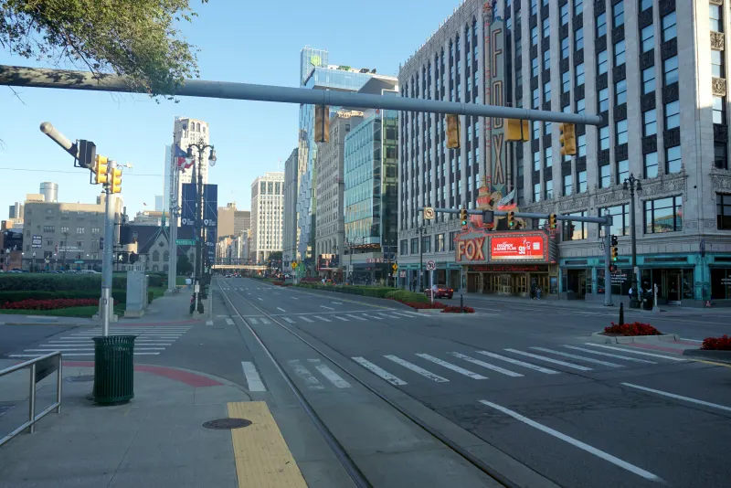 Woodward Avenue in downtown Detroit, Michigan, with crosswalks, traffic signals and the Fox Theatre