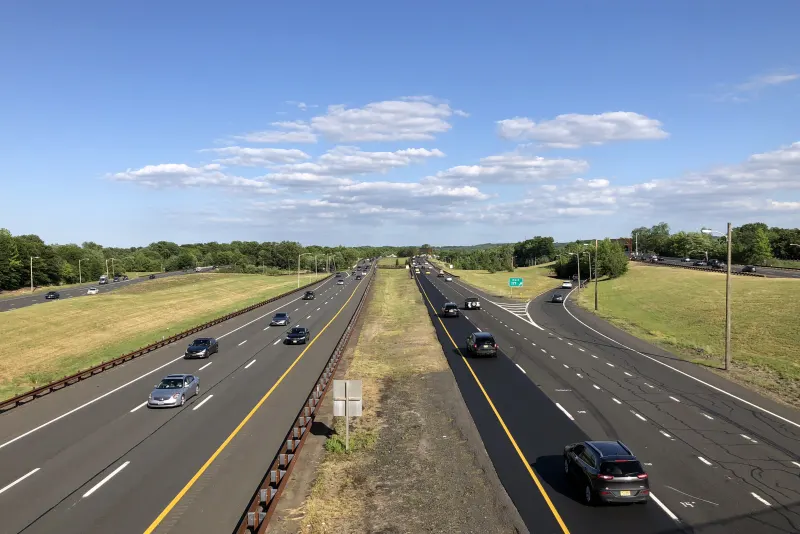 Cars on the Garden State Parkway under a blue sky in Hazlet Township, Monmouth County, New Jersey