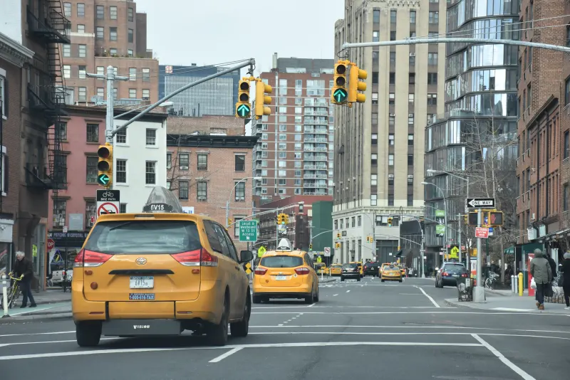 Yellow taxis and traffic lights on 8th Avenue at 12th Street in Manhattan, New York City