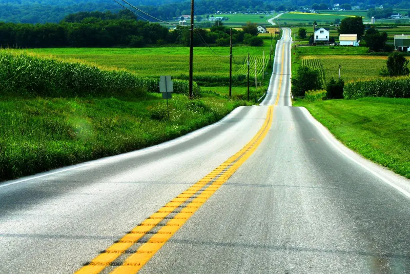 Rolling two-lane country road through green farmland in Lancaster County, Pennsylvania