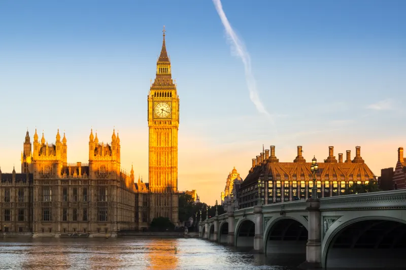 Big Ben and the Houses of Parliament at sunrise, seen across Westminster Bridge in London